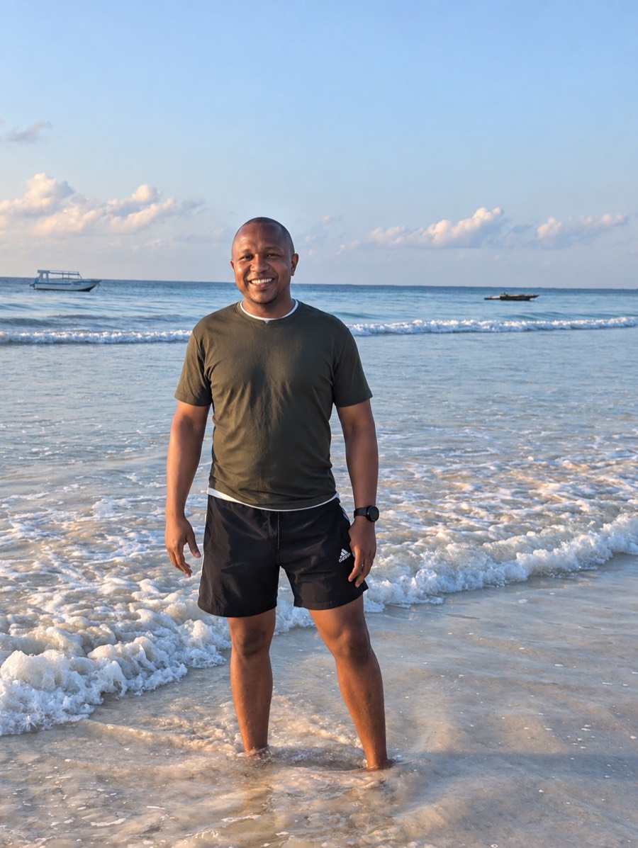 Sammy standing at the shoreline on the Kenyan coast