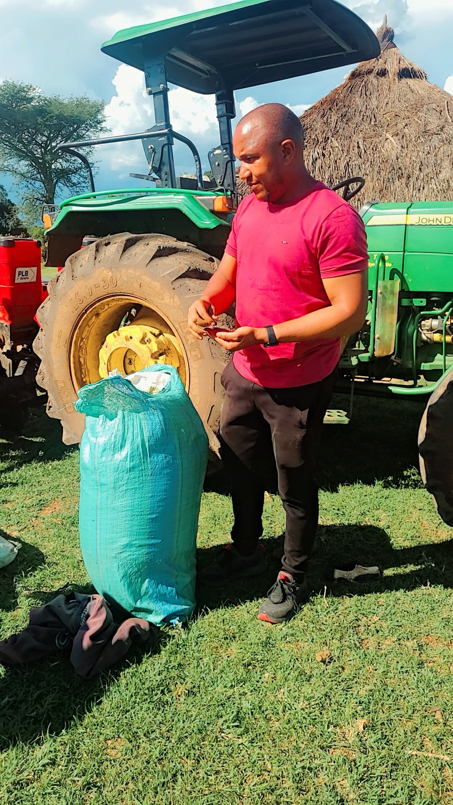 Sammy beside a tractor while working on the farm